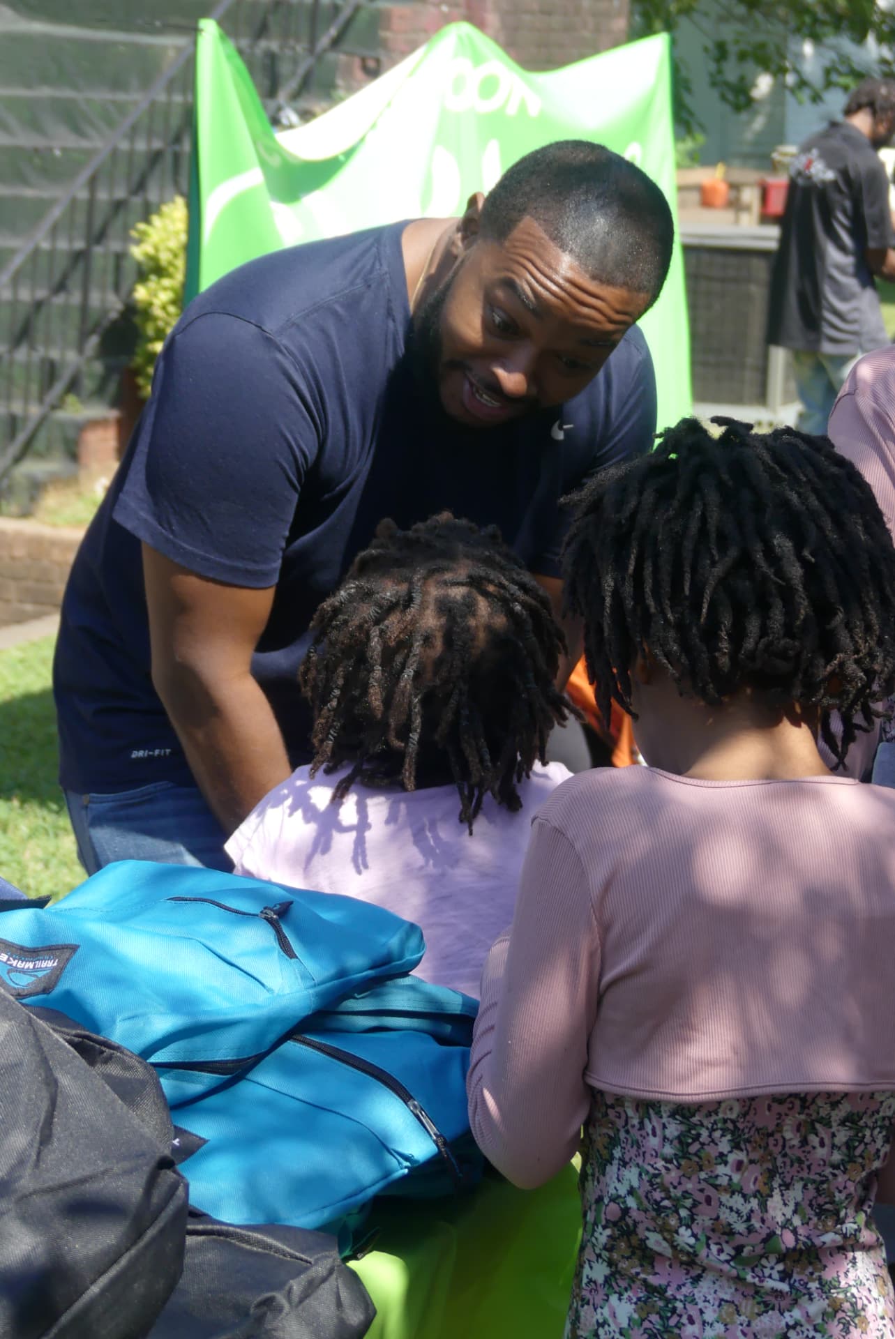Carlton Pulley helping students pick out backpacks filled with school supplies