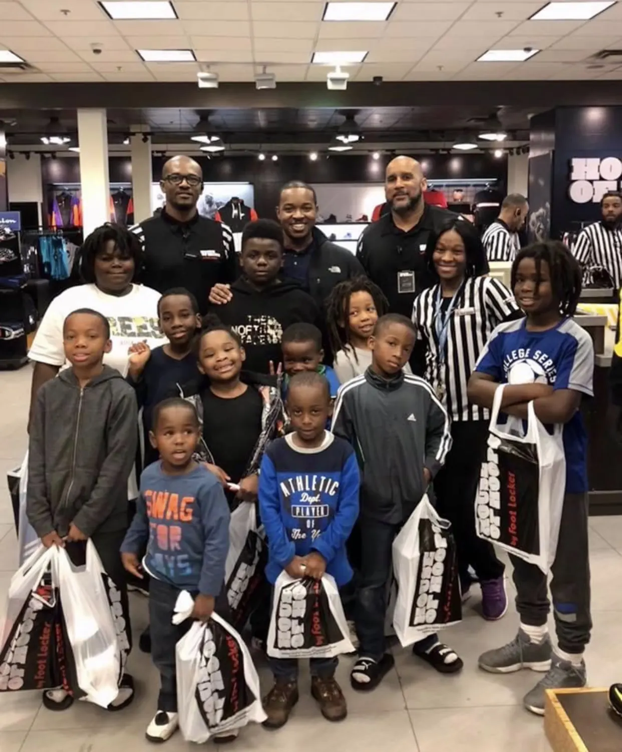 Students holding bags with their new sneakers